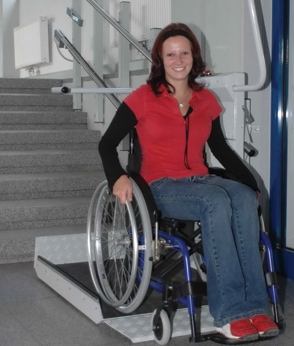 Smiling woman in a wheelchair using the Savaria Delta Inclined Platform Lift