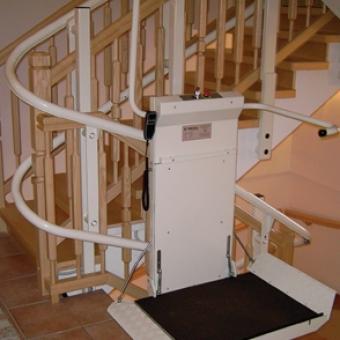 Savaria Omega Inclined Platform Lift attached to U-shaped stairs in a home